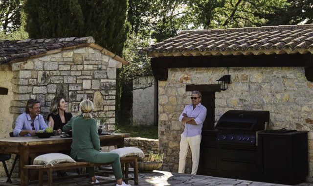 Napoleon Oasis® Matte Black modular outdoor kitchen with built-in grill and outdoor bar seating