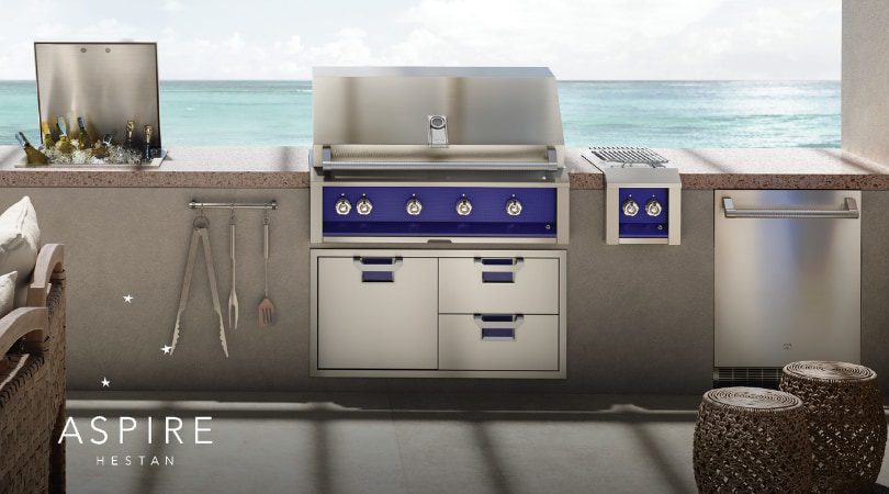 Hestan Outdoor luxury kitchen with stainless steel built-in grill and premium cabinetry at sunset