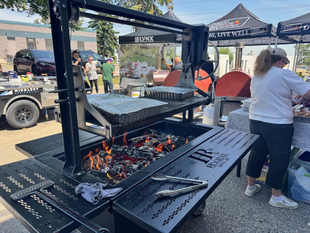 Hooray Santa Maria grill cooking pulled pork at Calgary Stampede event