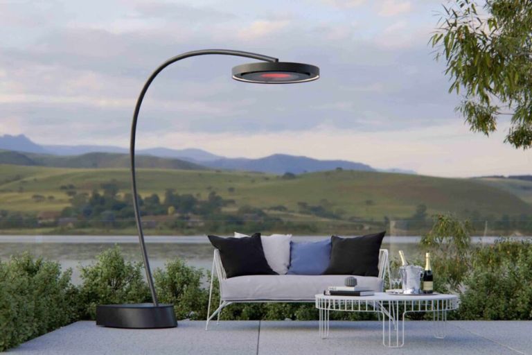 Freestanding outdoor heater beside lounge seating with a mountain and lake view