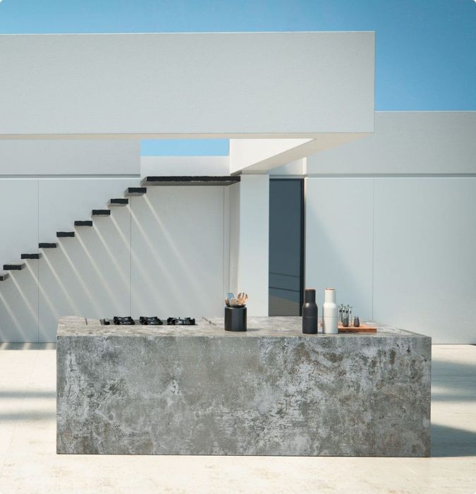 Dekton concrete-look countertop and cladding on a minimalist outdoor kitchen island